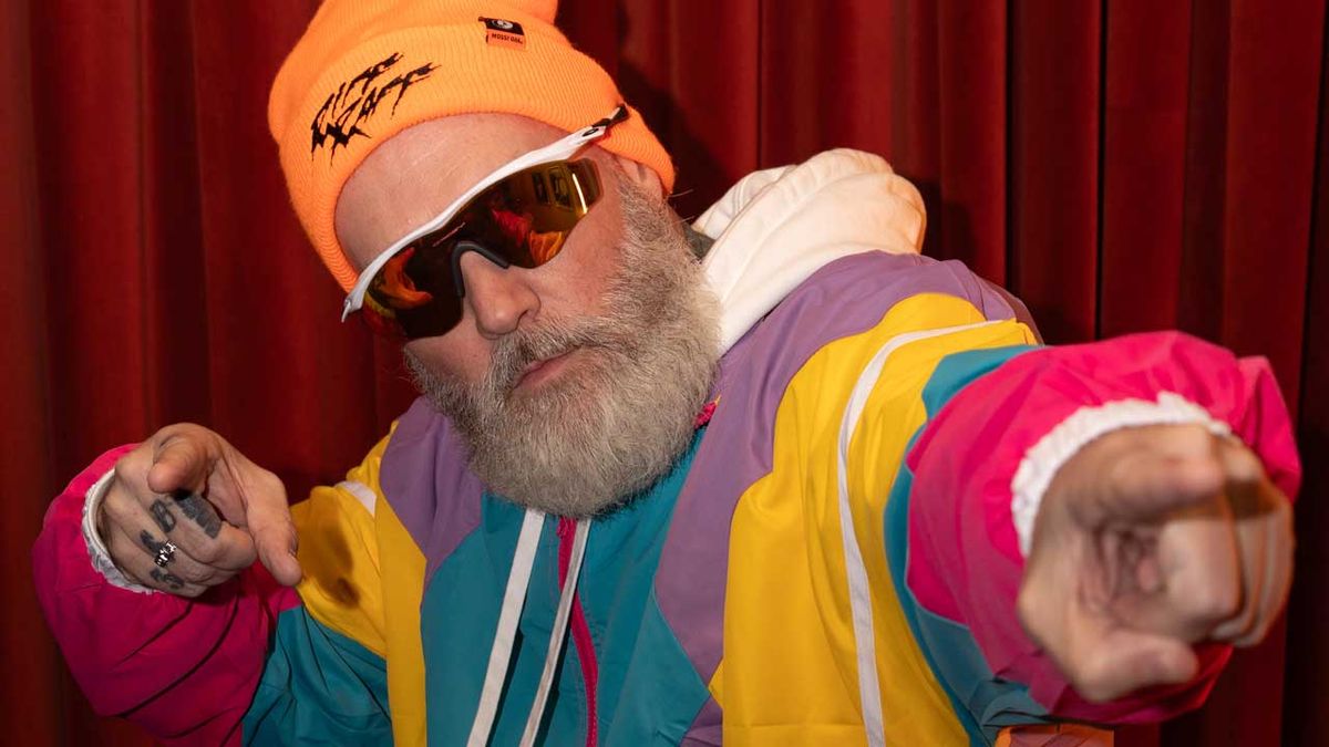 Fred Durst with beard in sunglasses and colourful tracksuit