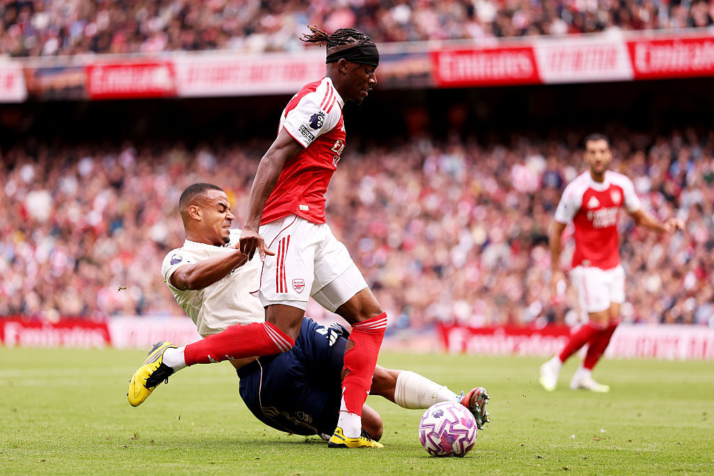 Murillo slide tackles Noni Madueke of Arsenal