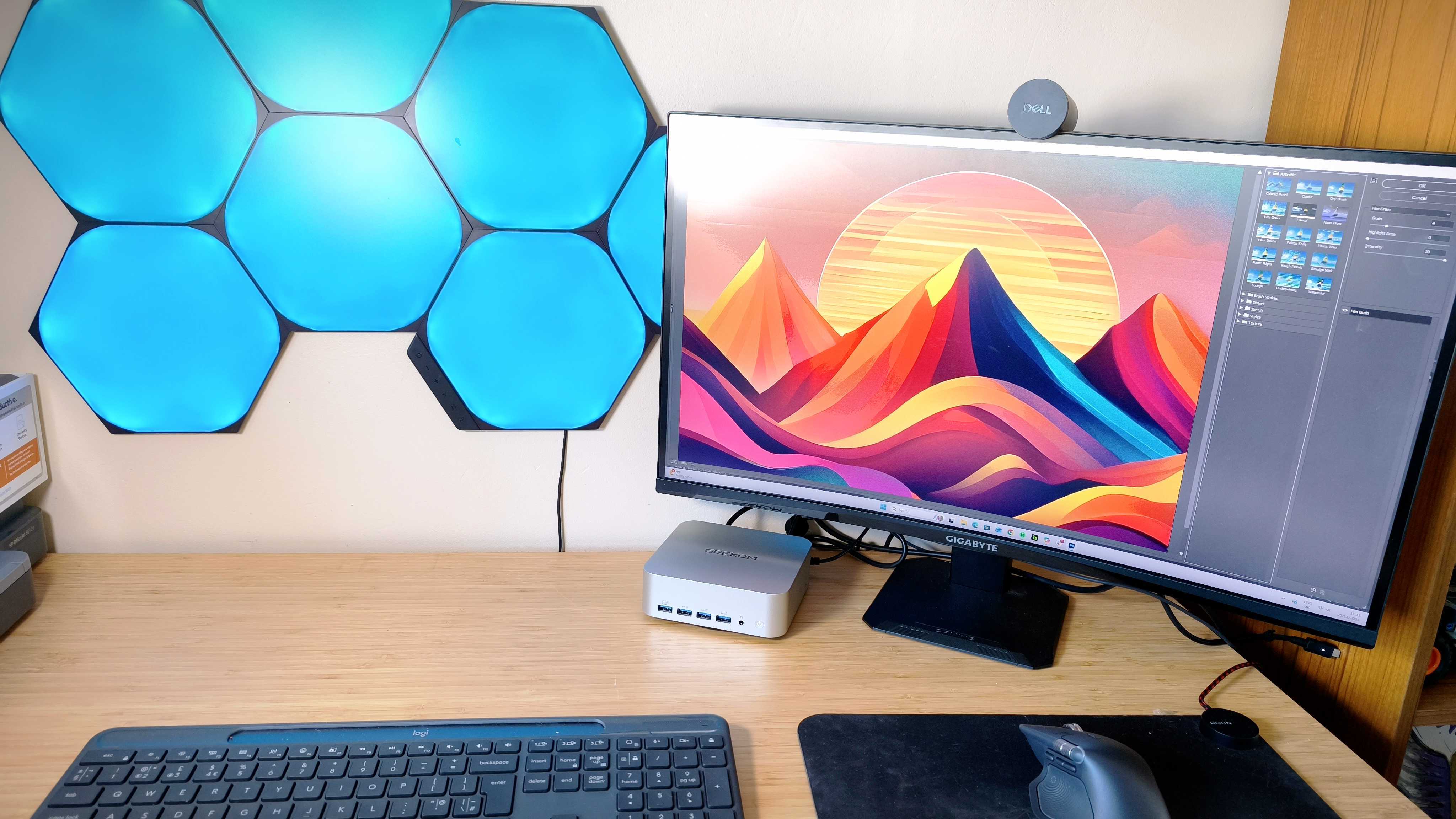 A silver Geekom A9 Max on a wooden desk