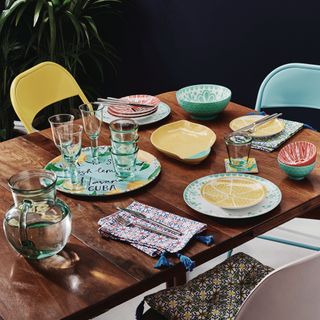 dining table with plates and glasses with glass jug