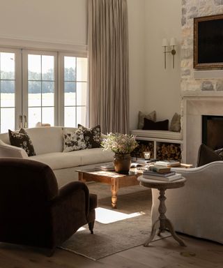 coastal living room with a large stone fireplace and neutral sofas