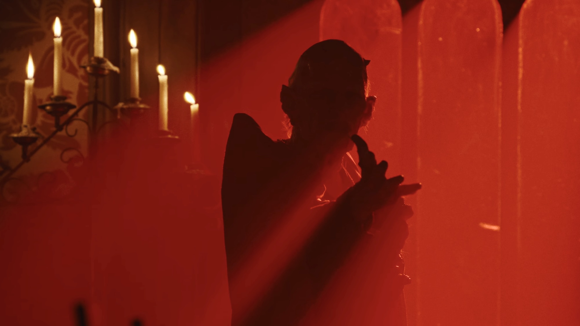 Demon cloaked in red light In American Horror Story 13