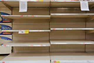 Panic buying of bottled water in shops during water shortage leaves shelves empty.