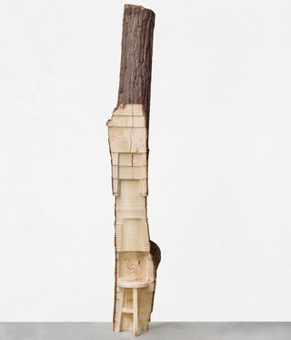 tree trunk sculpture against white background