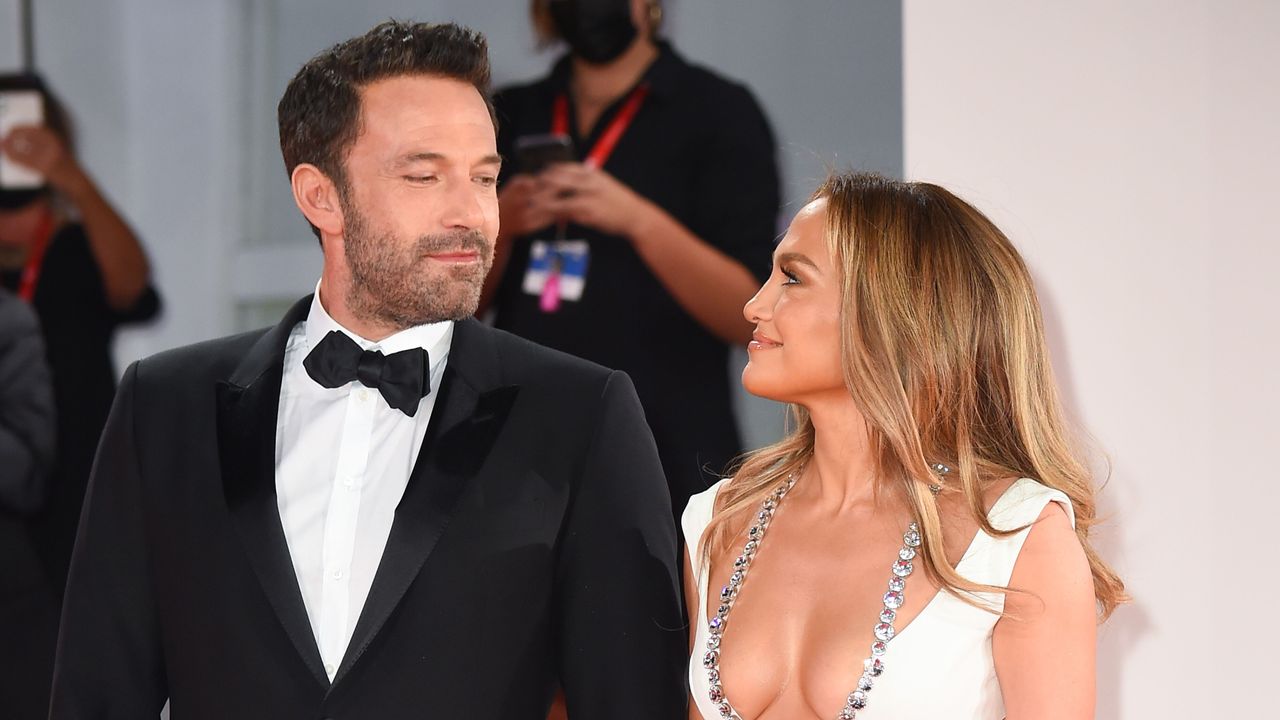 Ben Affleck and Jennifer Lopez look lovingly at one another as they walk the red carpet.