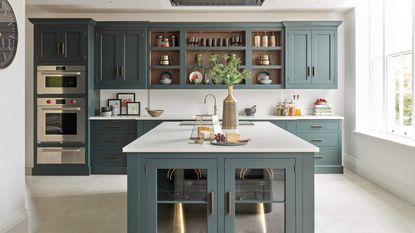 A kitchen with blue cabinetry by kitchen designers, Tom Howley