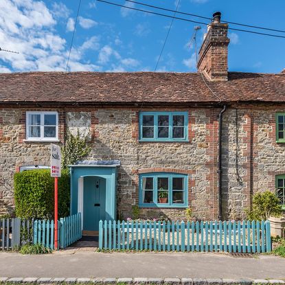 house with fence and blue door