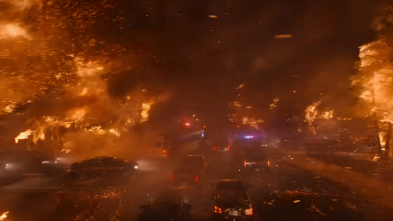 A dramatic shot of a raging inferno over a road in The Lost Bus