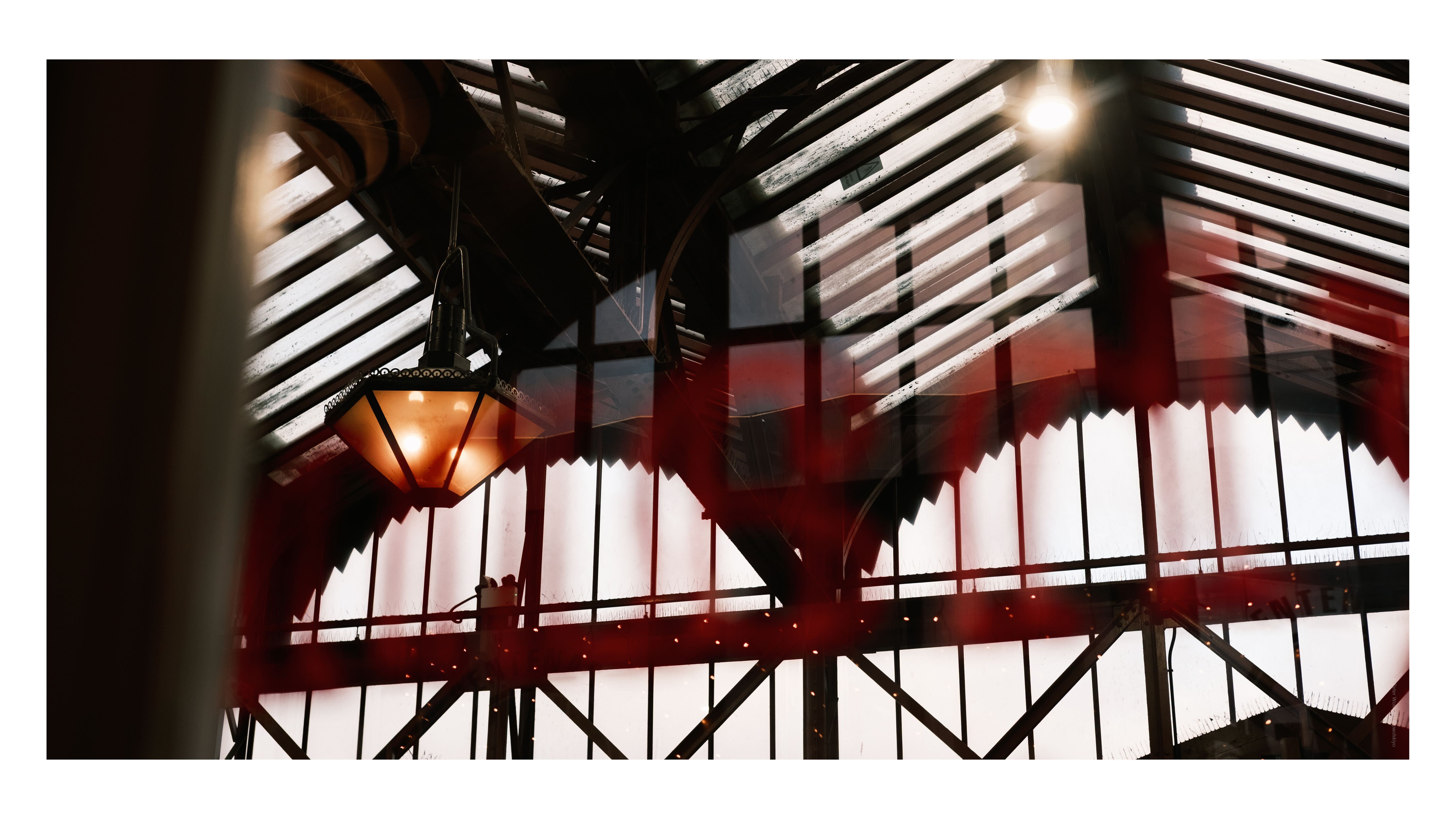 A photo of two lamps on a train station ceiling, taken on the Fujifilm X-E4