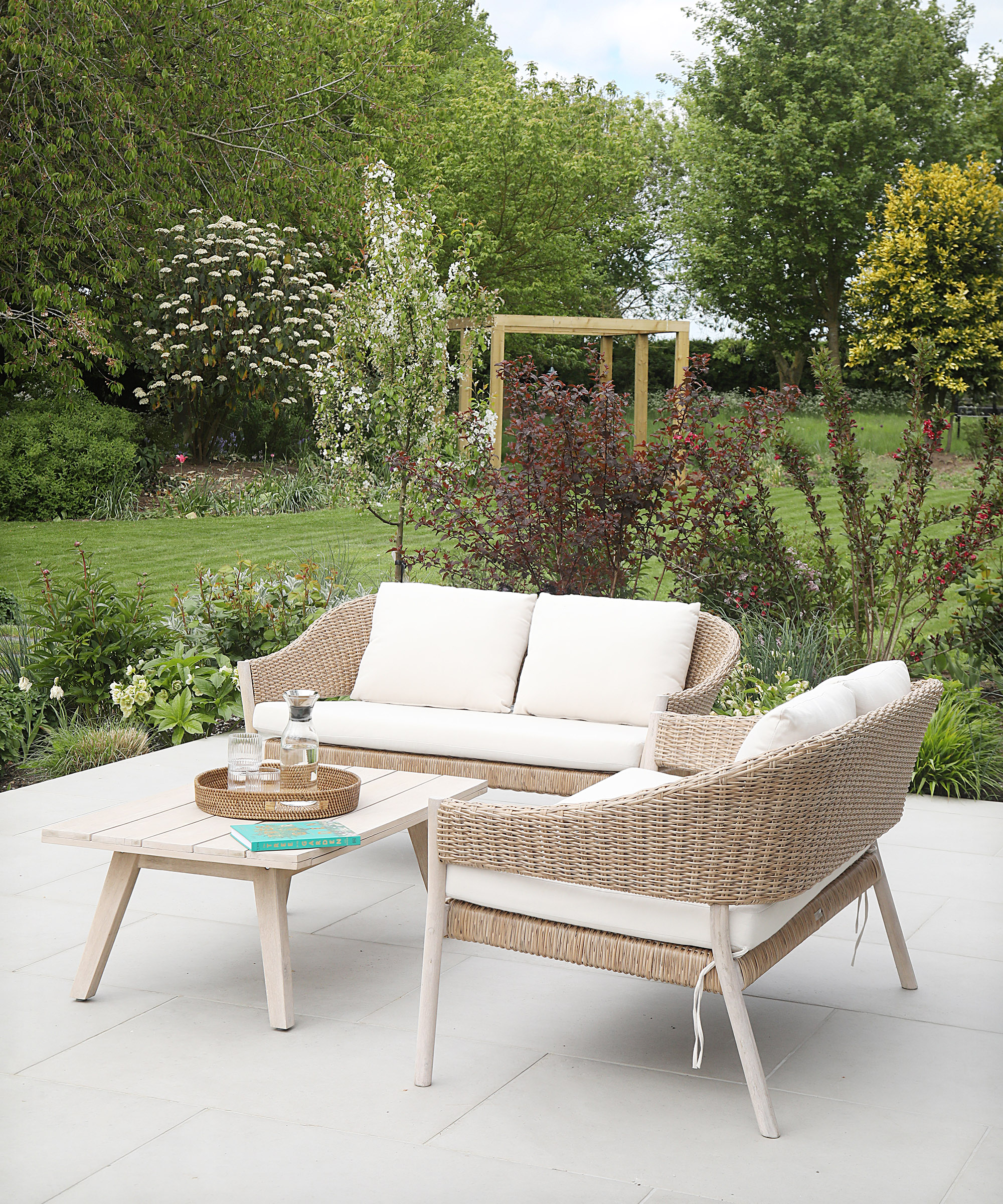 A light patio with a small sofa and armchair and coffee table set