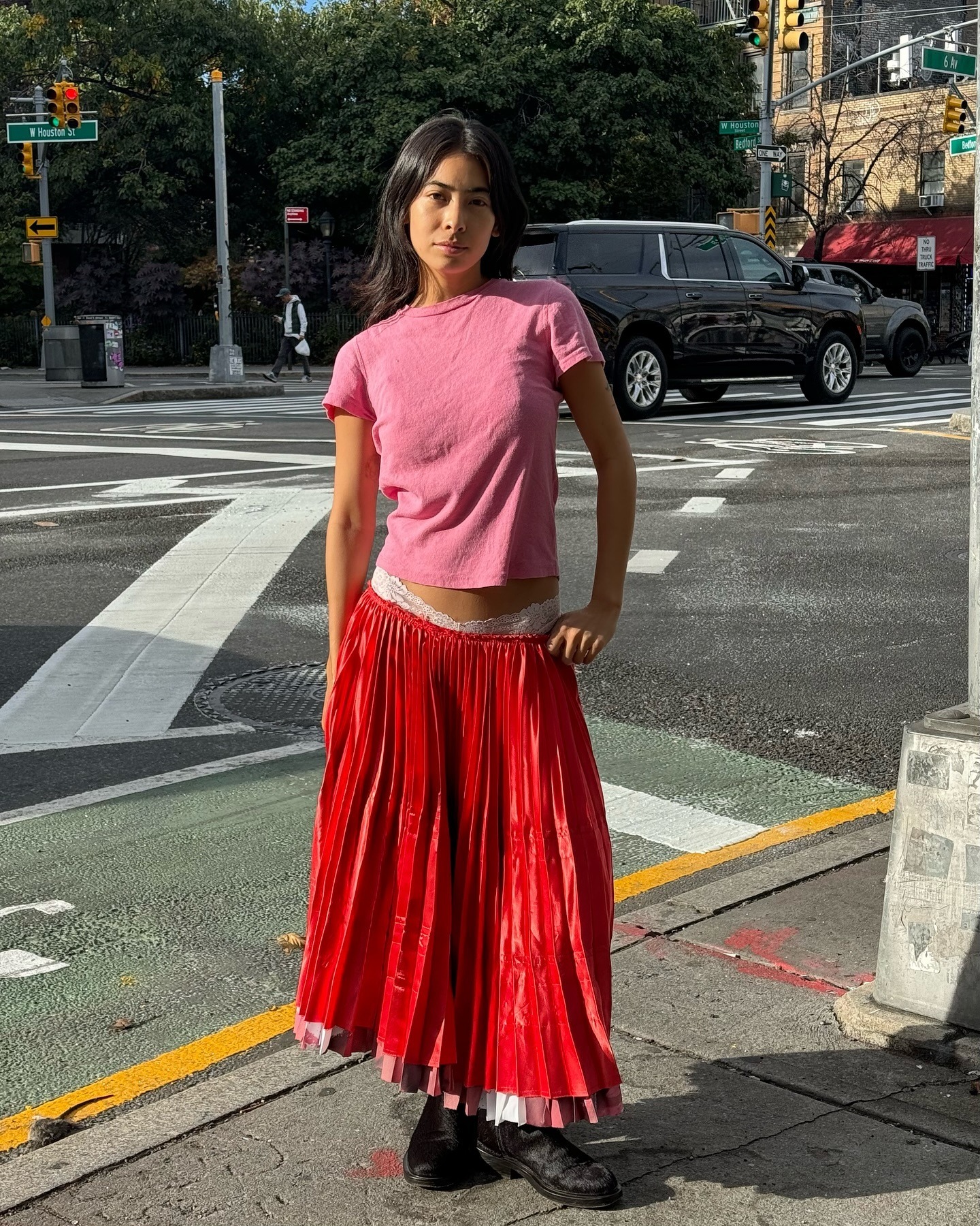 A photo of Michelle Li wearing a red skirt and pink tee shirt