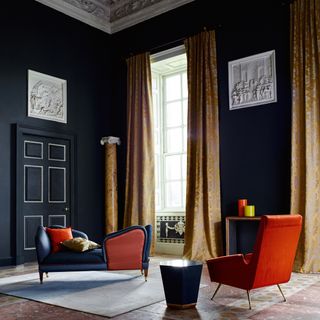 living area with blue wall and white window with curtains and armchairs