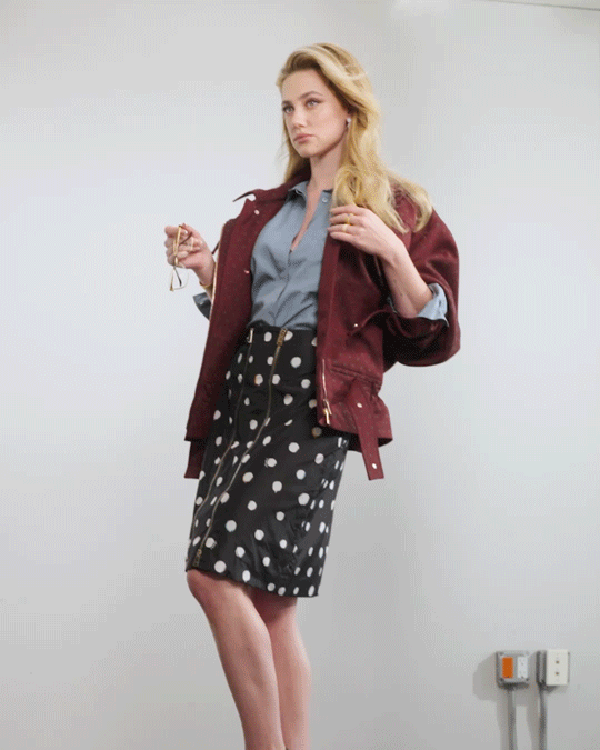 a moving image of Lili Reinhart holding glasses, then wearing them as the camera zooms in and out