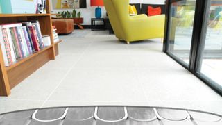 living room with floor tiles exposed showing underfloor heating below