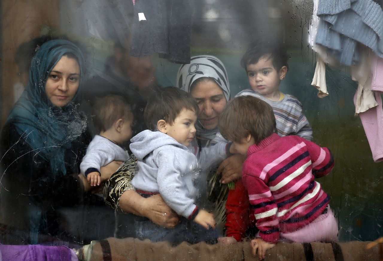 Syrian refugees wait in a camp