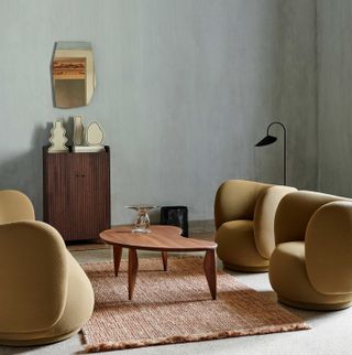 a modern living room with armchairs around a coffee table
