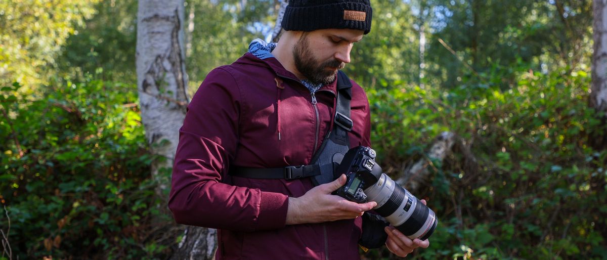 Cotton Carrier Skout G2 worn by a man in a burgandy jacket outdoors in a woods