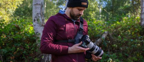 Cotton Carrier Skout G2 worn by a man in a burgandy jacket outdoors in a woods