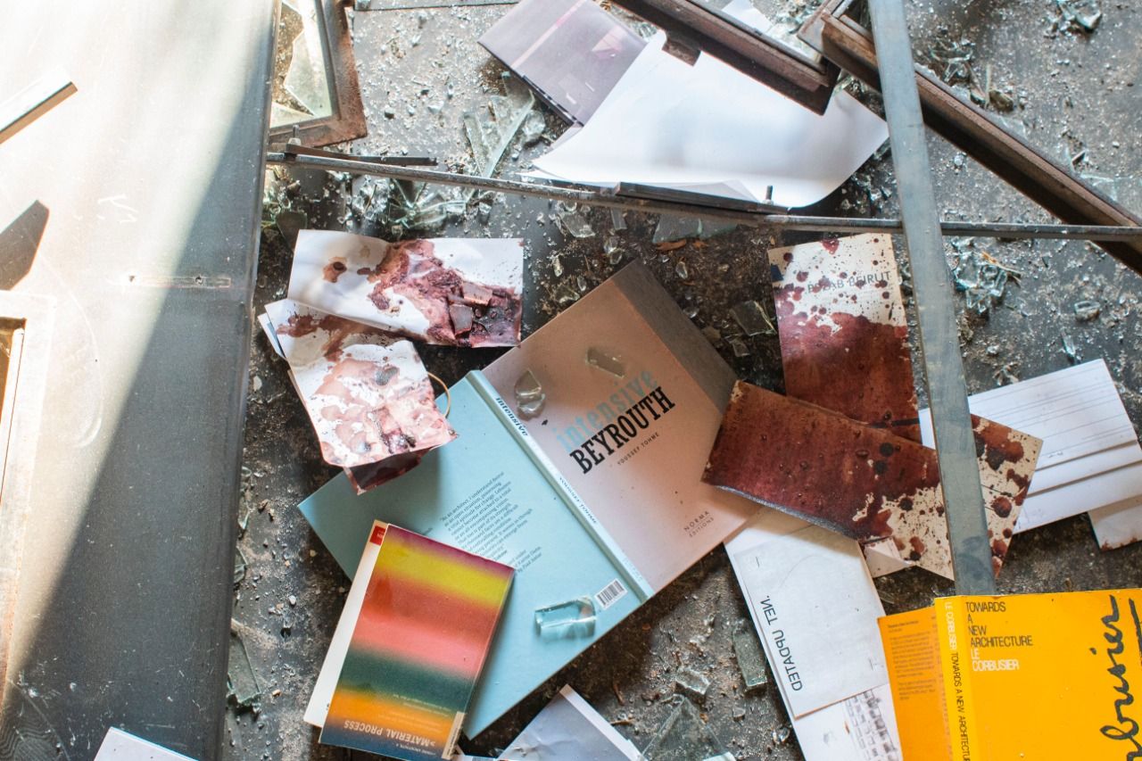 Bloodied papers, scattered books and glass shards on the floor of PSLab&#039;s Beirut HQ