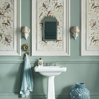 bathroom with washbasin and blue wall mirror