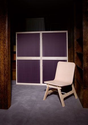 Interior room, grey floor, neutral coloured chair, dark wood wall frames, purple and neutral framed divider screen
