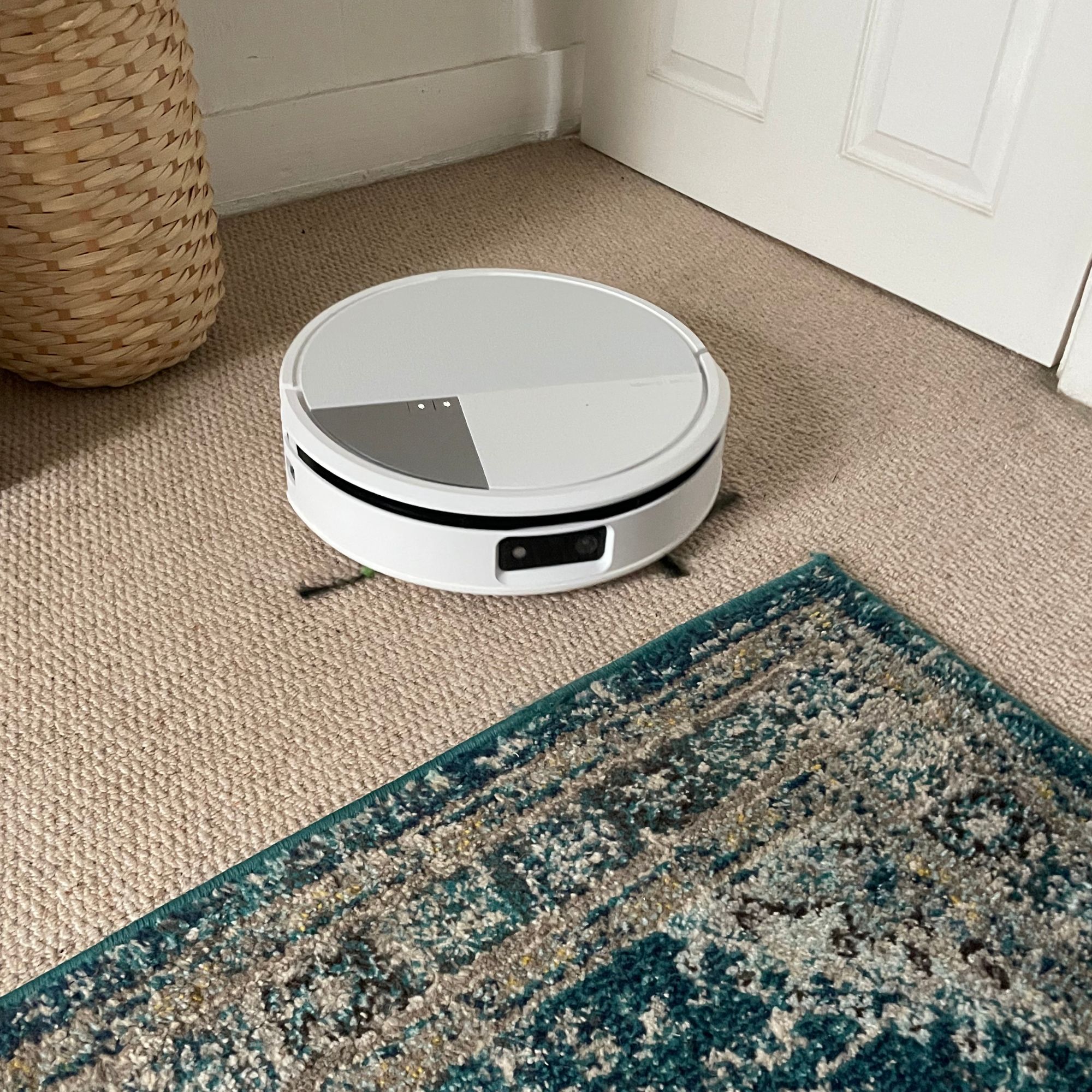 iRobot Roomba Max 705 Combo Robot Vacuum Cleaner and Mop on carpet, next to a blue rug