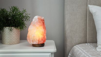 Salt lamp placed on table in bedroom