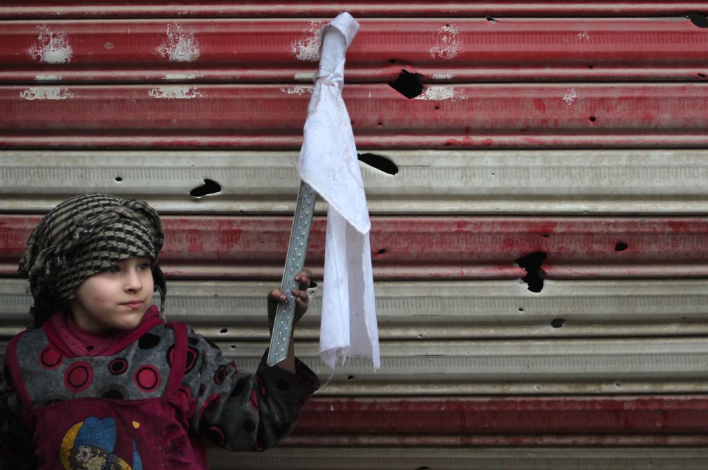 An Iraqi girl holds a white flag