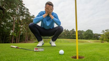 Golfer with head in hands 