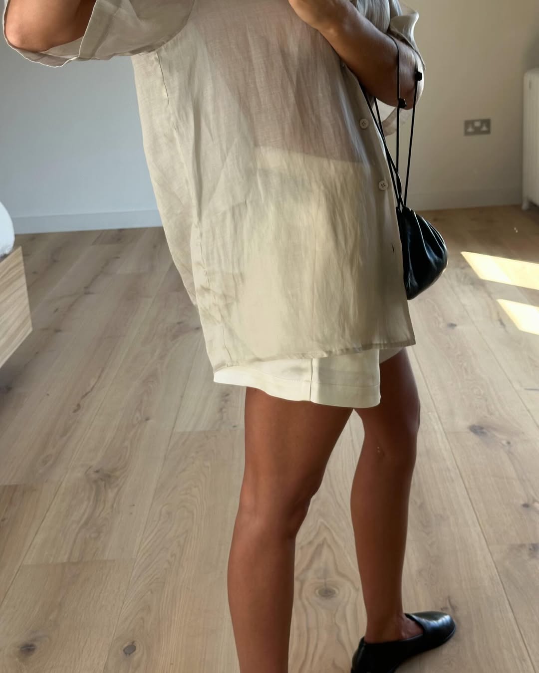 Woman wearing the silk shorts trend.