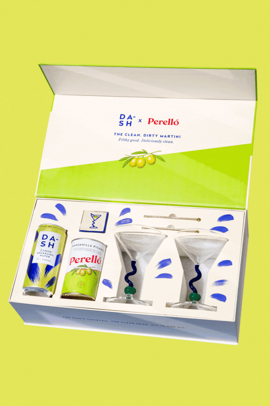 A GIF of a clean, dry martini kit with a pair of martini glasses, a can of soda. a pair of cocktail picks, a pair of cocktail napkins, and a tin of olives