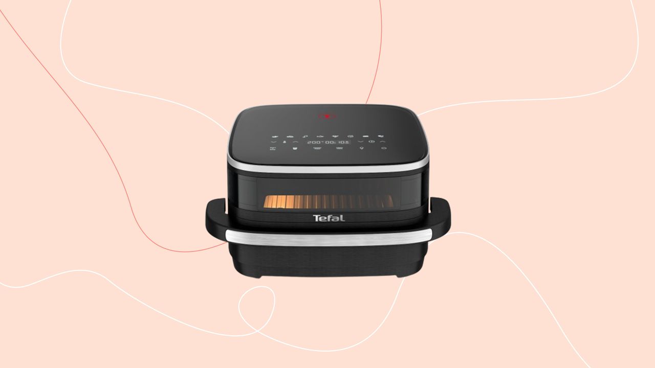 Tefal&#039;s pizza sized air fryer on a pink Ideal Home style background