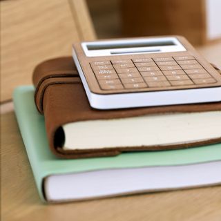 stack of books wooden calculator