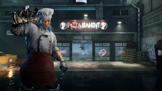 A pizza chef holds a rifle over his shoulder in the parking lot of his shop named Pizza Bandit 