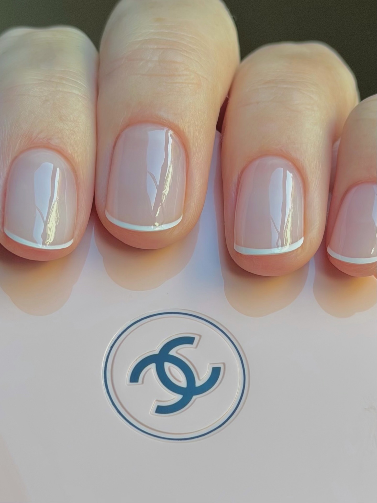 A close-up of a white micro French manicure