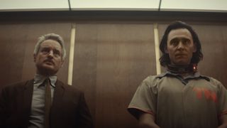 Mobius played by Owen Wilson and Loki played by Tom Hiddleston stood in an elevator.