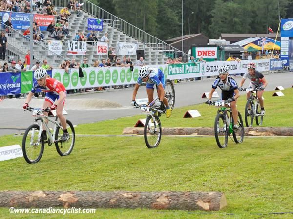 Katarina Nash goes up on her front wheel after the first half log obstacle