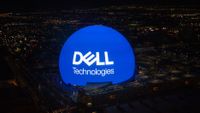 A photo of the Sphere in Las Vegas, bearing the Dell logo in white against a blue background to mark Dell Technologies World 2024. Decorative: The photo has been taken from above, with the city of Las Vegas surrounding the Sphere far into the distance.
