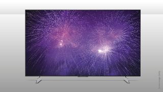 LG OLED42C4 TV with purple fireworks on screen against a grey background