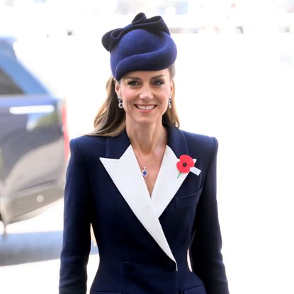 Kate Middleton wearing a coat dress from ALEXANDER MCQUEEN with jewelry from Prince William and Princess Diana