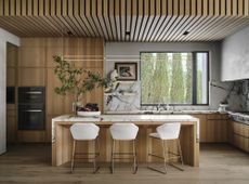 A kitchen with white marble countertops 