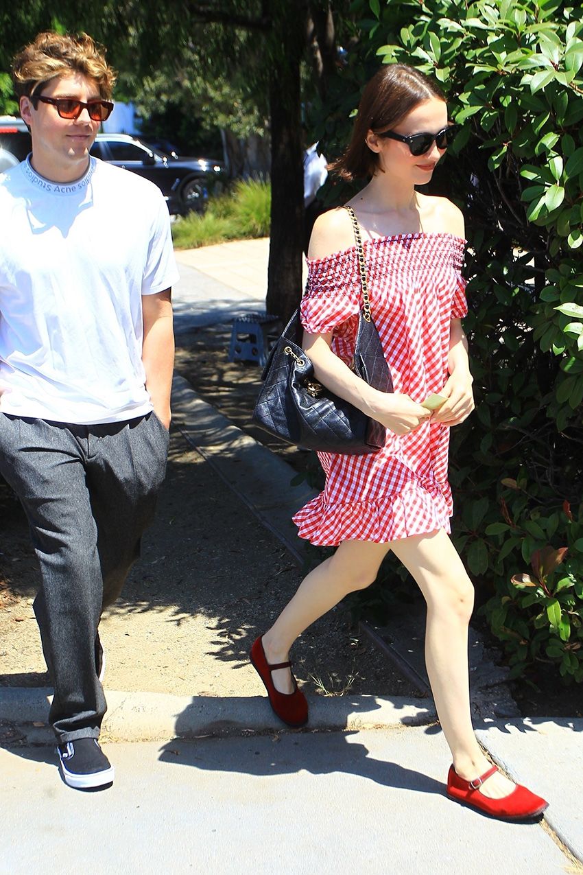 Maude Apatow wearing a Frankies Bikinis red gingham dress and red Mary Janes