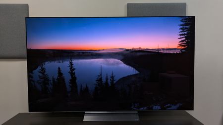 The LG C6 OLED TV with a sunset over a lake taken from a hillside. The shot shows the C6's contrast, detail and color accuracy, with the colors of the sunset looking authentic 