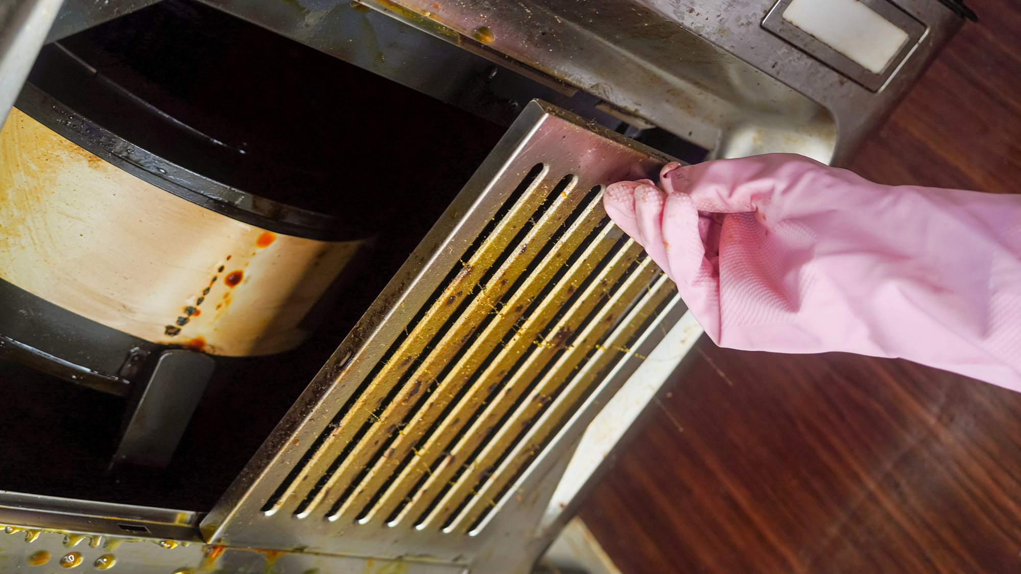 Dirty extractor fan filter being removed