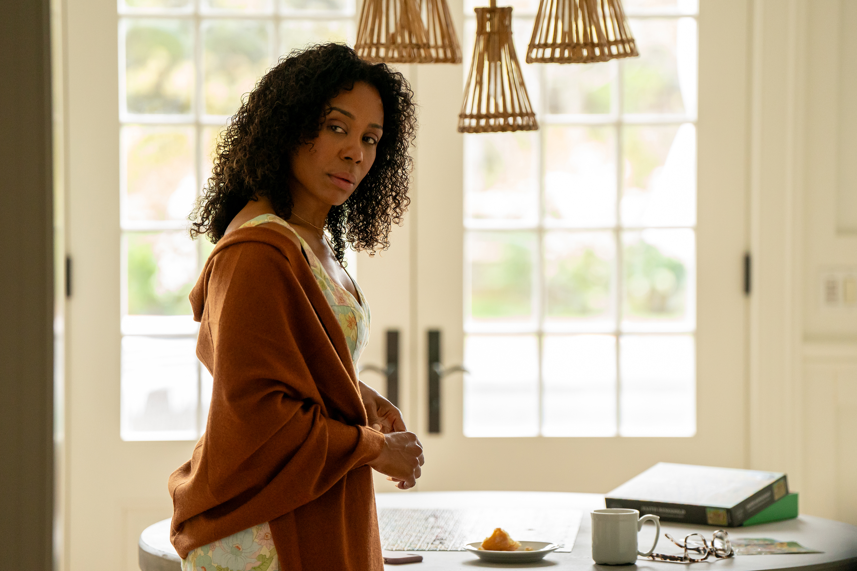 Karen Pittman as Dawn Edwards wearing a brown shall and standing by the kitchen table in the tv show forever