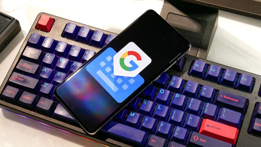 Gboard app logo on mobile phone resting on a keyboard