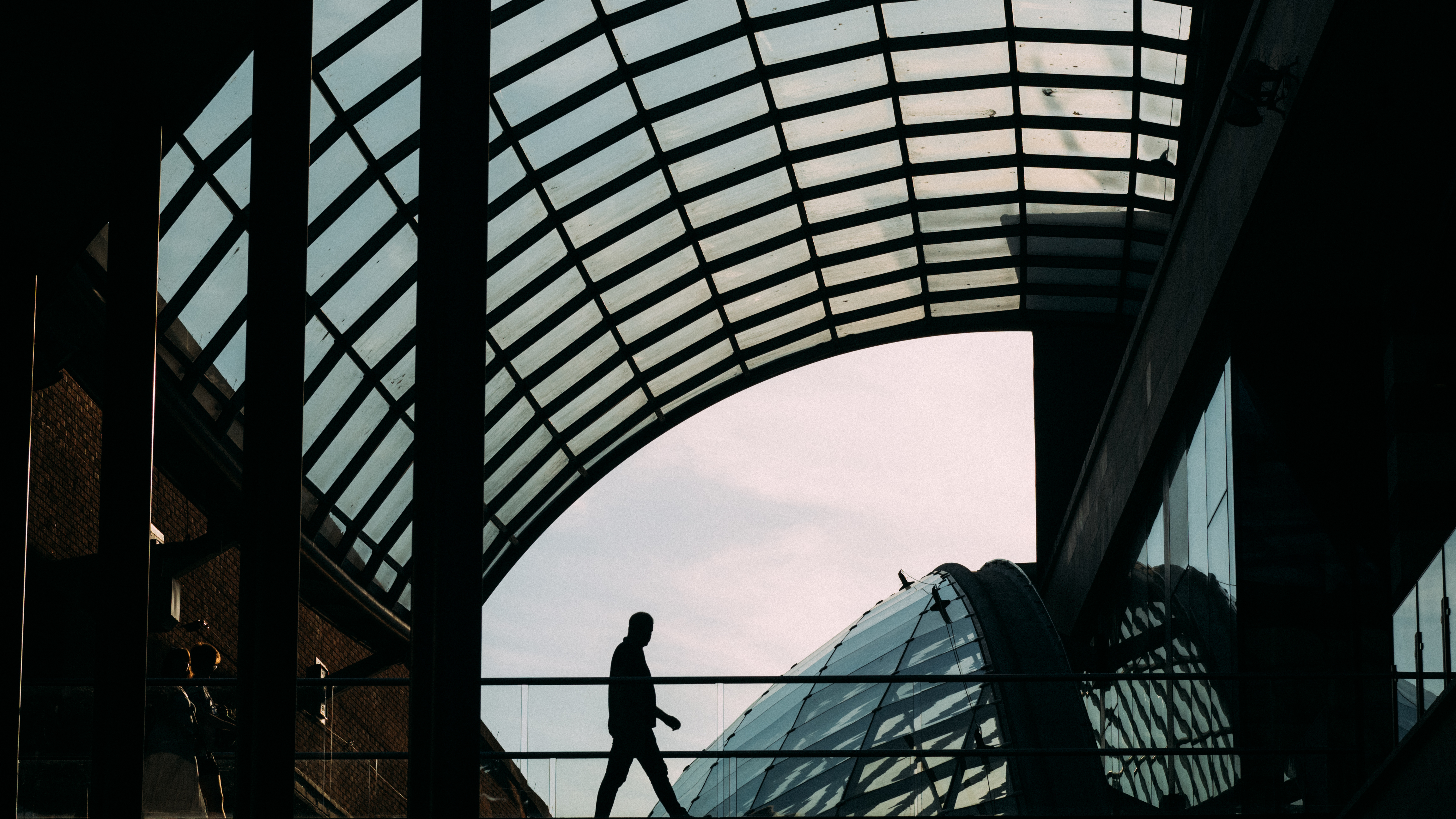 A silhouette of a man walking across a walkway in Bristol, Olympus EM-5 Mark II sample images