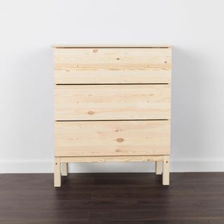chest of drawers on brown floor