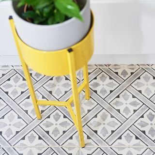 tiles flooring with yellow pot holder and white pot