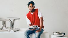 Andu Masebo with the stainless steel objects and furniture he designed for Ikea